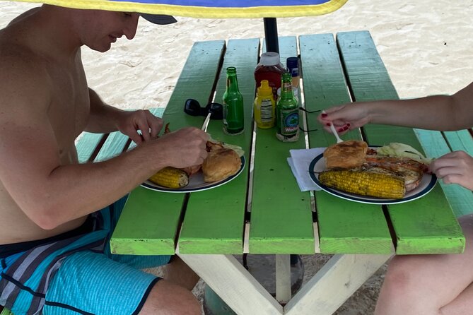 Dickinson bay beach - Rum punch and a beach-cooked lobster lunch